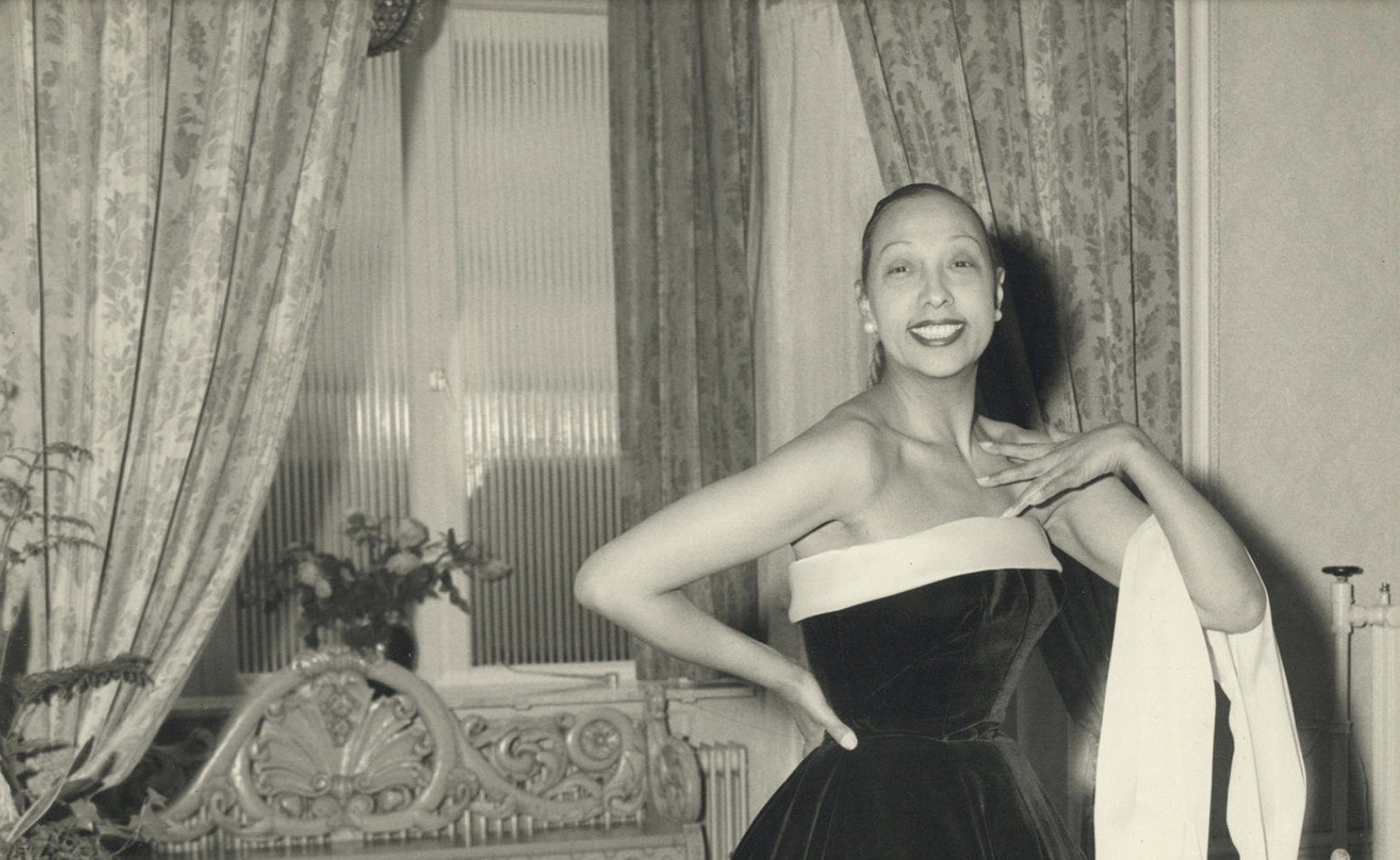 black and white photograph of Josephine Baker who wears a ball gown