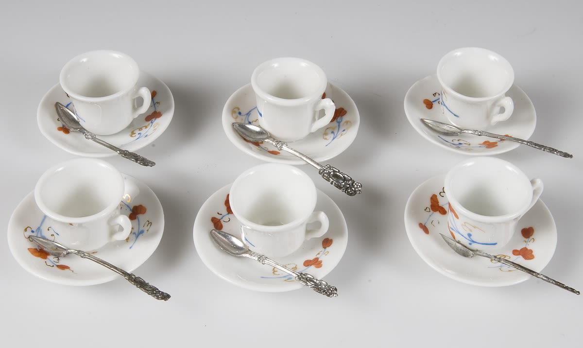 A set of six tea cups with spoons