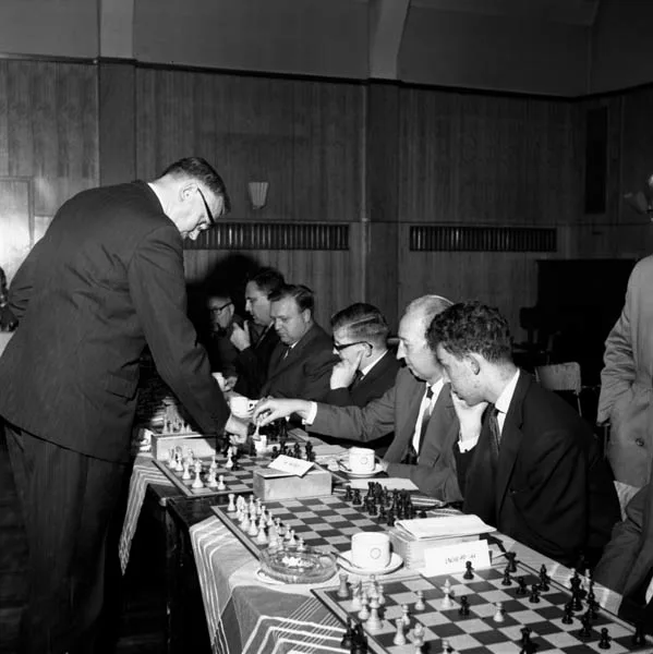 black and white photograph of Max Euwe standing while playing chess