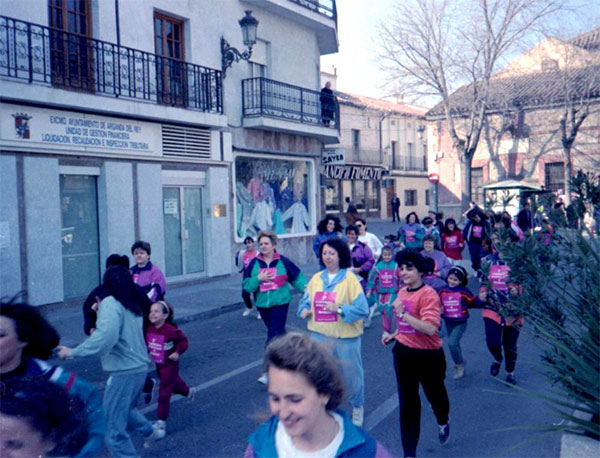 colour photograph, group of people running in a race in a city street