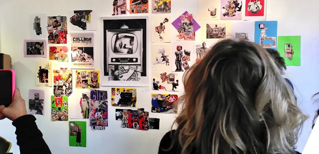 People seen from behind looking at collages mounted on the wall of a gallery