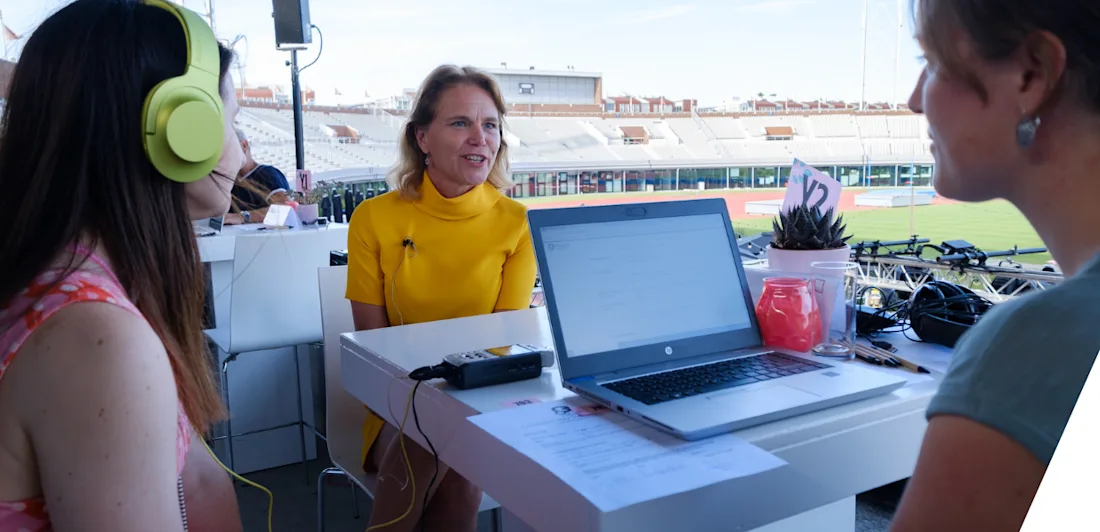 People sat around a table at the Amsterdam Olympic Stadium