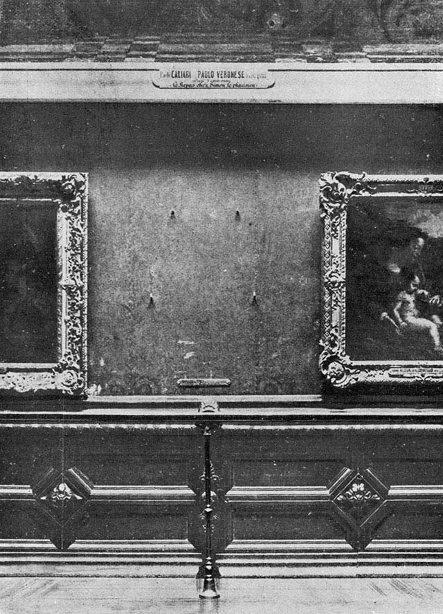 black and white photograph of empty wall space where the Mona Lisa had been