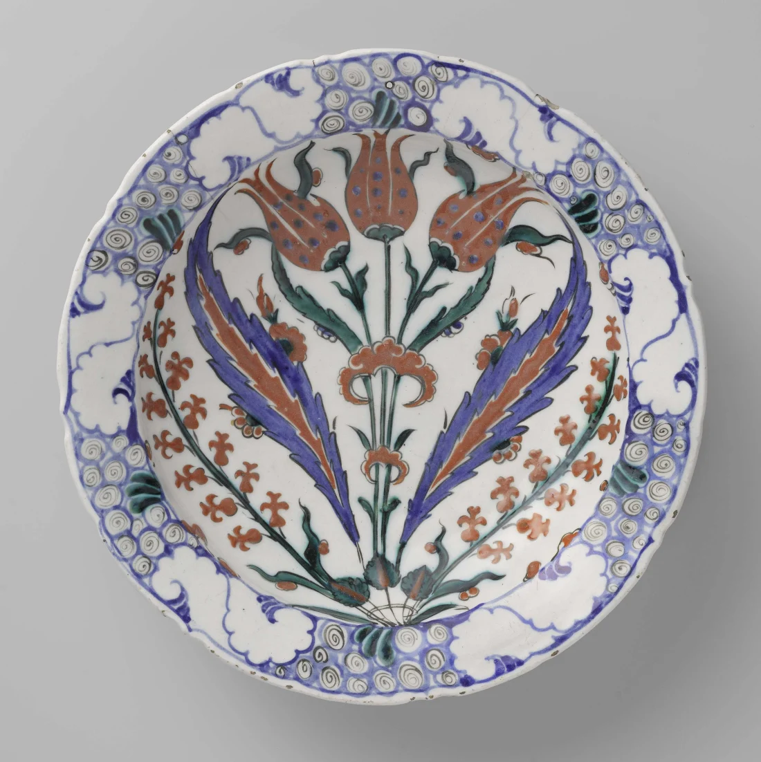 colour photograph, ceramic plate with blue, red and green floral motif