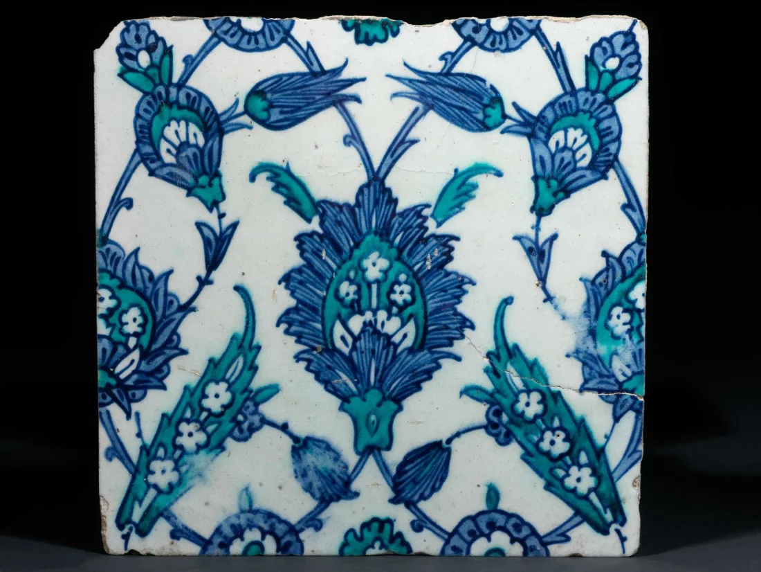 colour photograph, a white tile with blue floral motif