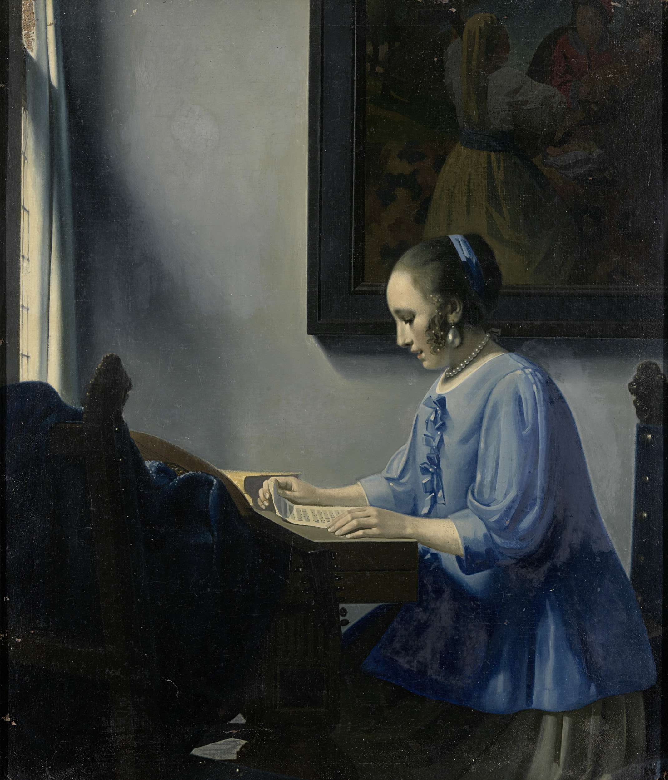 painting: a woman wearing blue, sitting at a desk reading a letter.