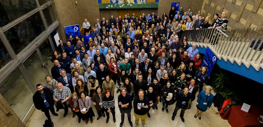 A large group of people (the Network Association) looking up at the camera