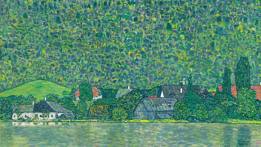 colourful painting showing buildings on a lake shore with forested hills behind