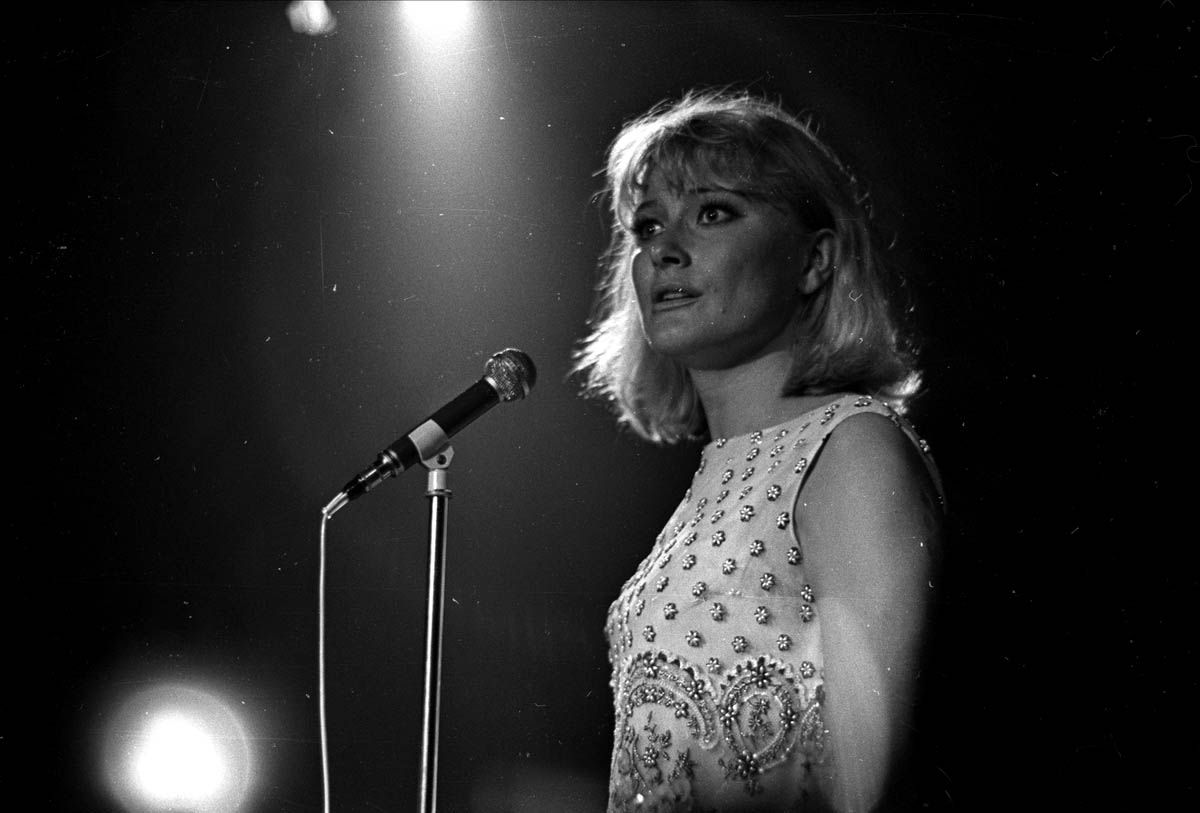 black and white photograph, Monica Zetterlund singing by a mic stand.