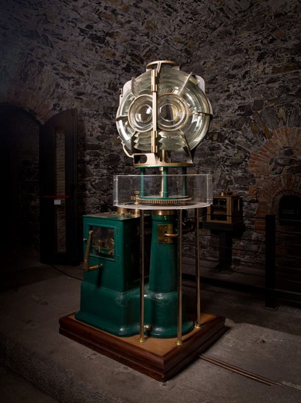 large lighthouse lens with a green base