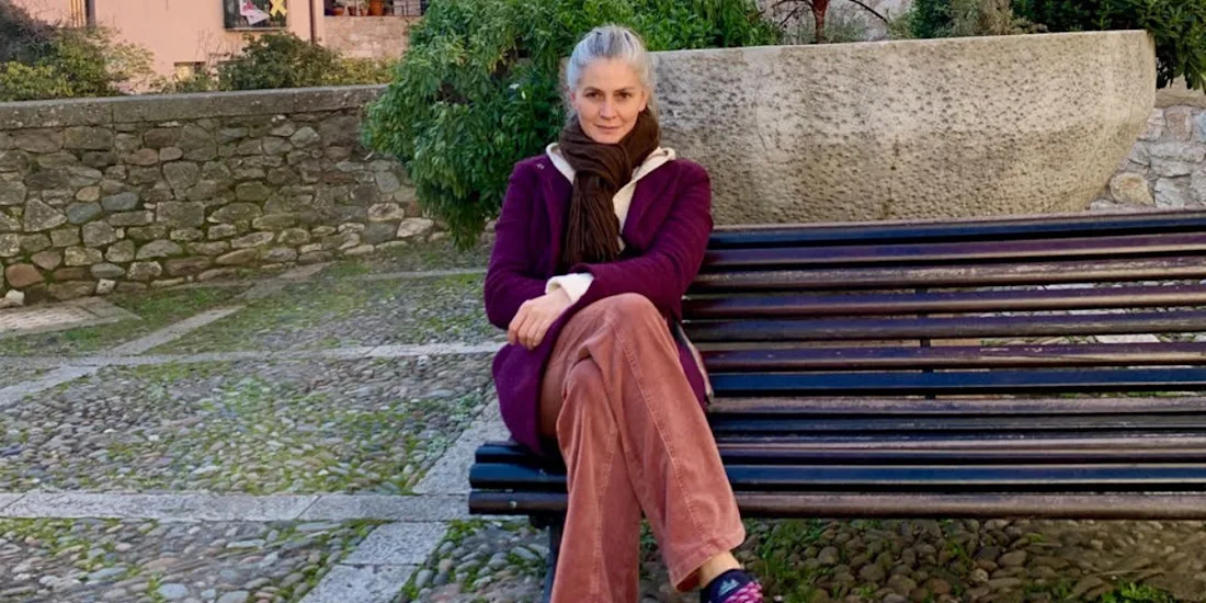 A photograph of Maria-Cristina Marinescu sitting on a bench