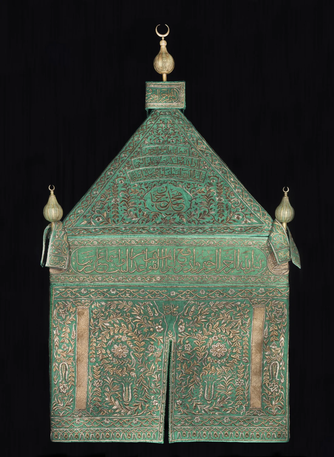 mahmal cover and finial banners of green silk, embroidered in silver and silver-gilt wire over cotton thread padding; finials of gilded copper alloy are of a later date