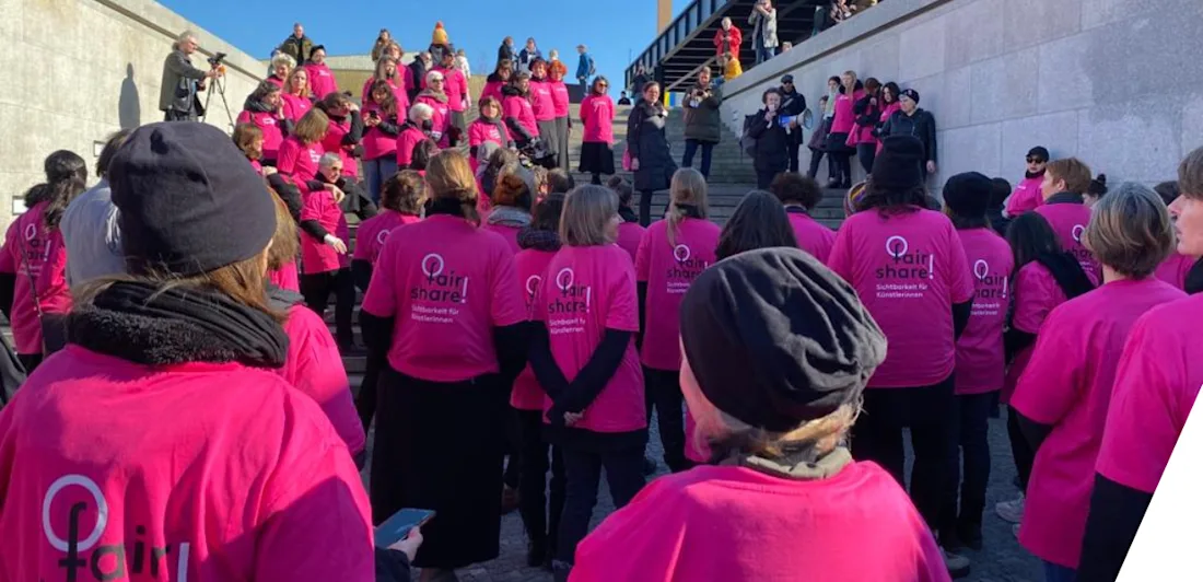 People marching wearing pink t-shirts