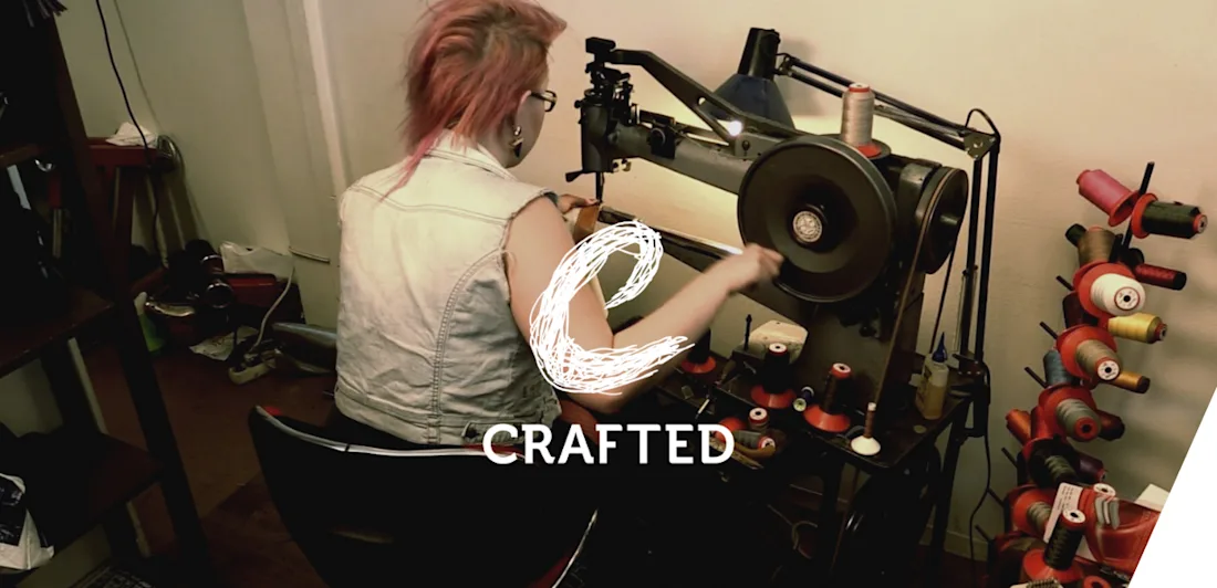 Someone seen from behind using a sewing machine