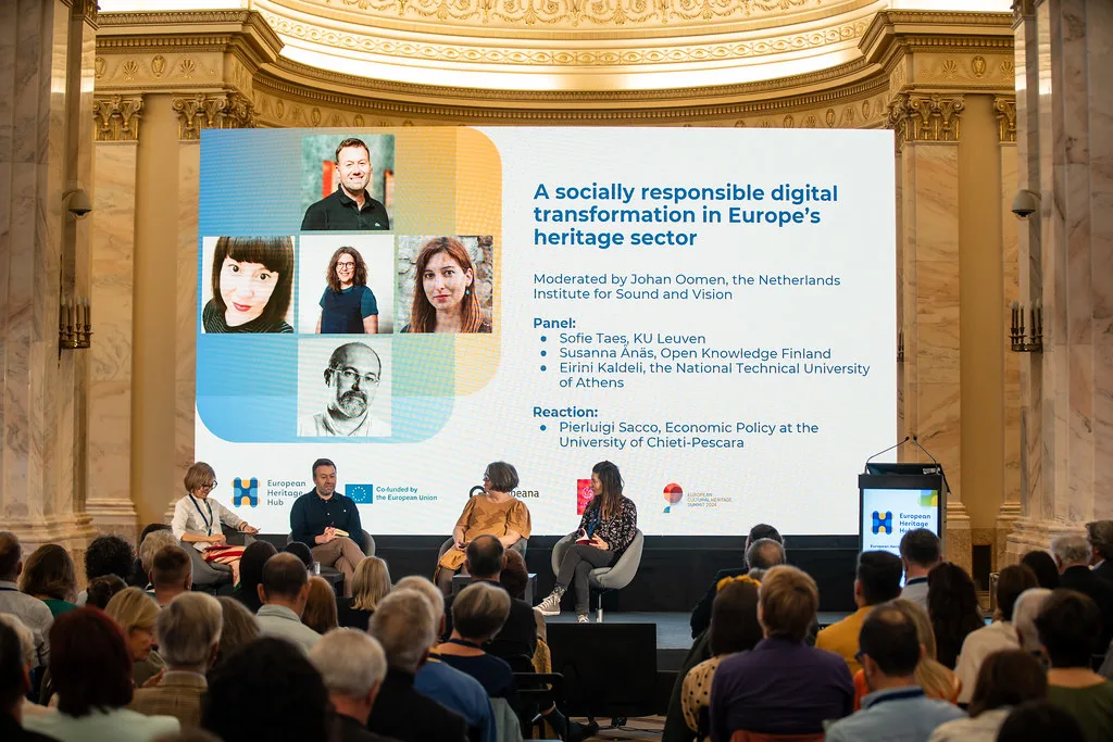 A panel conversation in front of a live audience