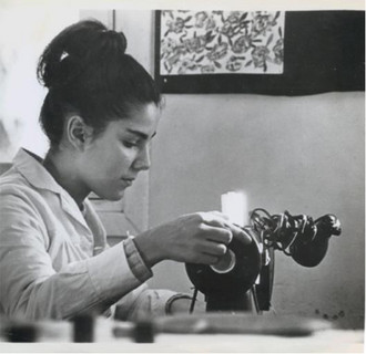 black and white photograph of a young woman using a piece of equipment
