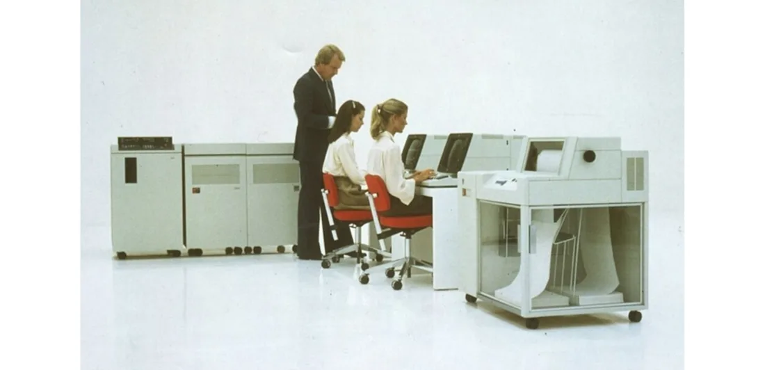 Two individuals focused on their computers