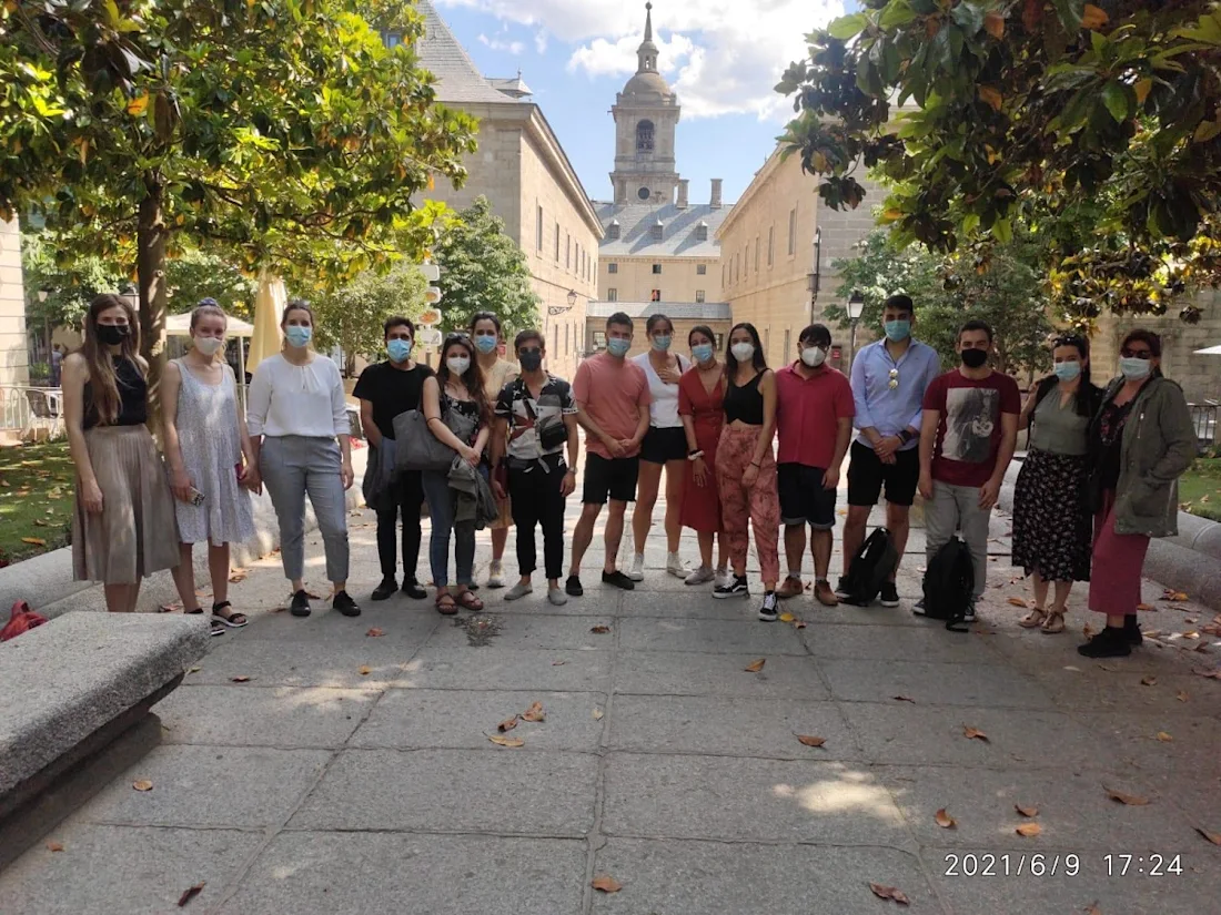 A group fo new professionals stood in front of a monastery