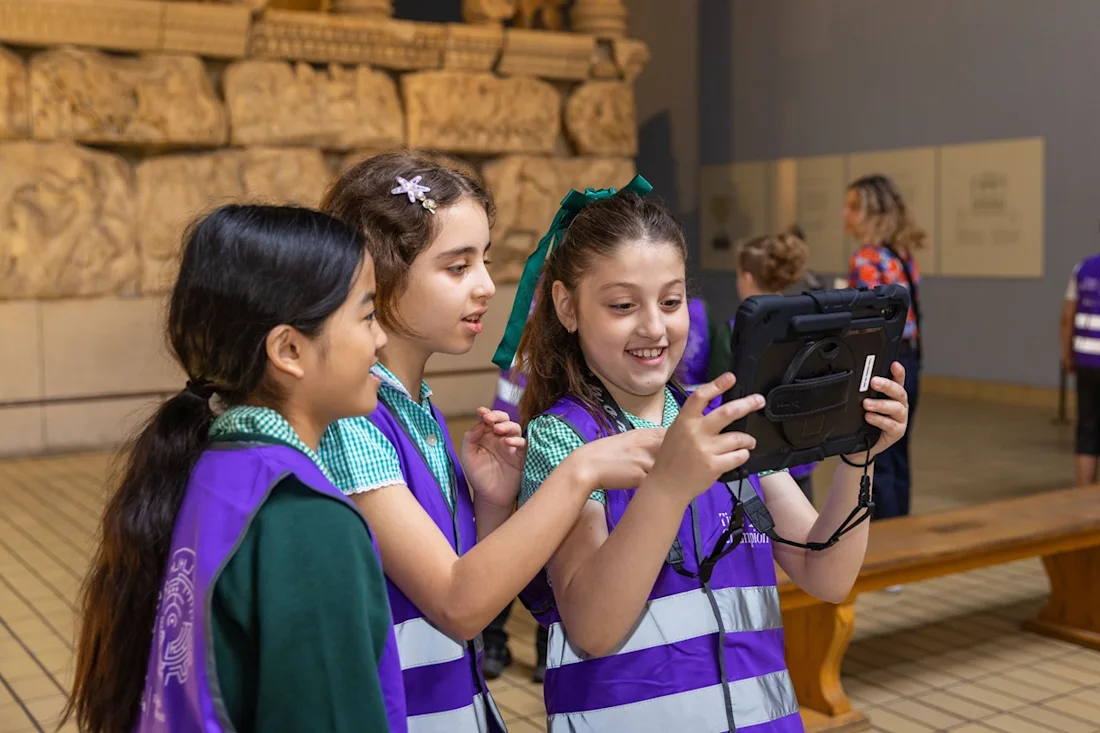 Children interact with Time Odyssey through a tablet. 