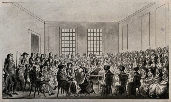 'Elizabeth Fry is seated at a table in a large room surrounded by men and women prisoners listening to her', Wellcome Library, London. Copyrighted work available under Creative Commons by-nc 2.0 UK