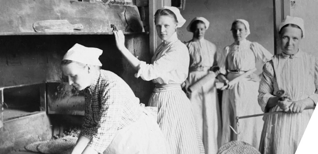 Women baking bread in a picture taken around the turn of the last century.