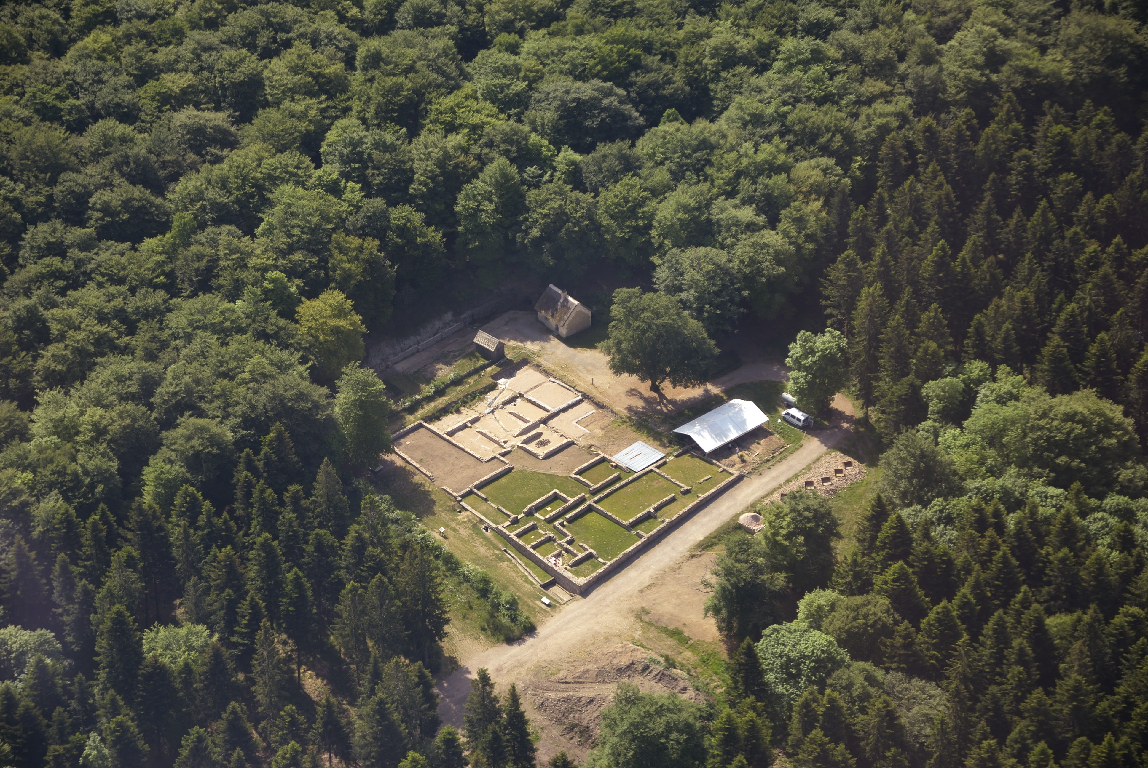 an aerial photograph of an archaeological site, showing the ruined remains of old walls and buildings.