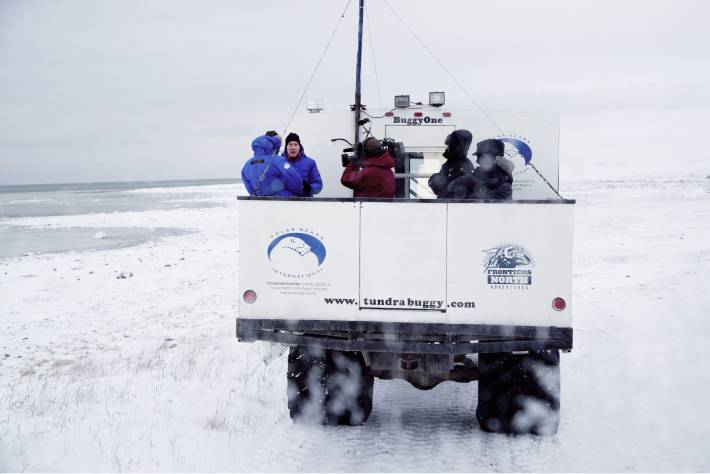 Tundra Buggy One traveling on ice with researchers on board