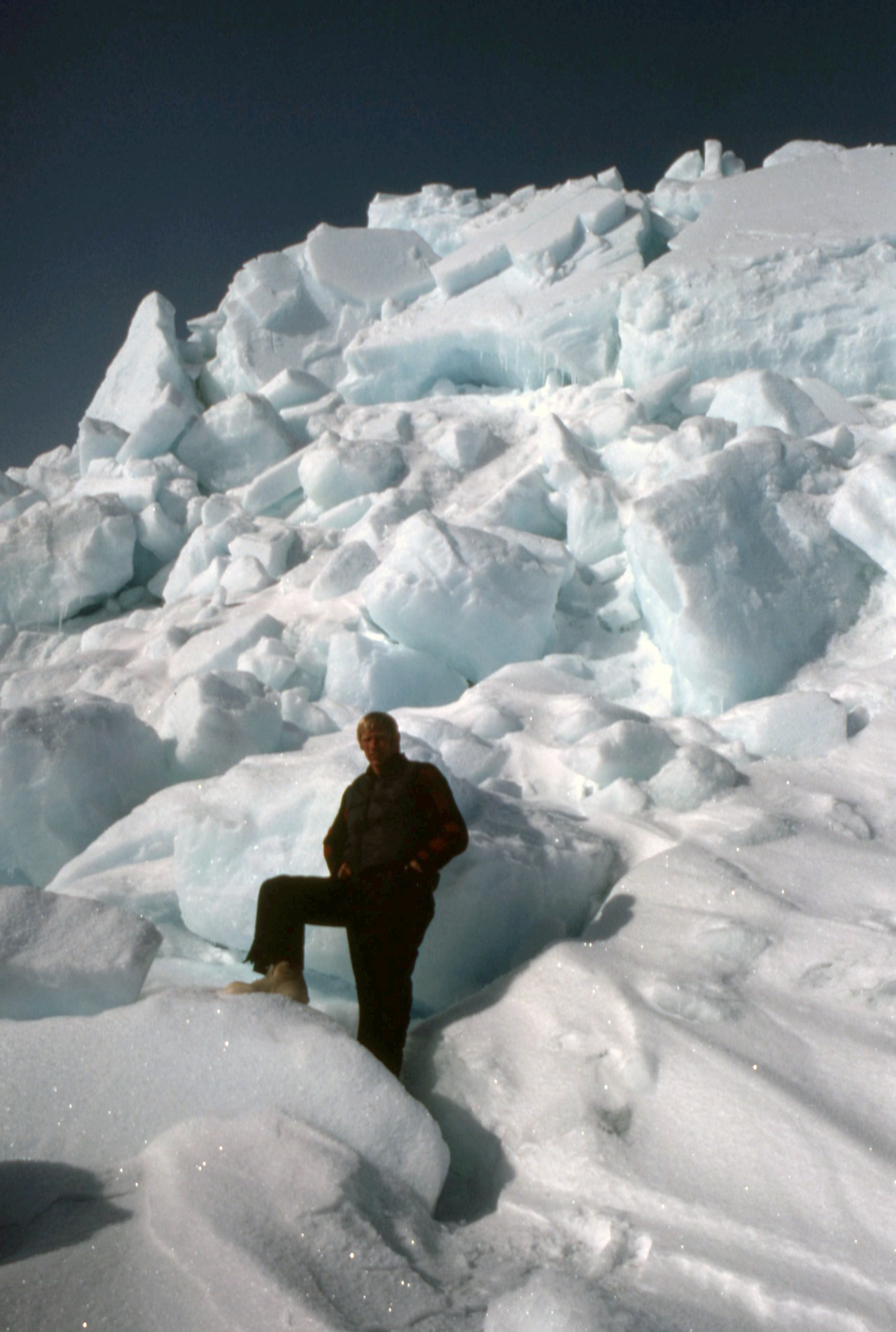 Steve Amstrup in front of a large pile of ice. 