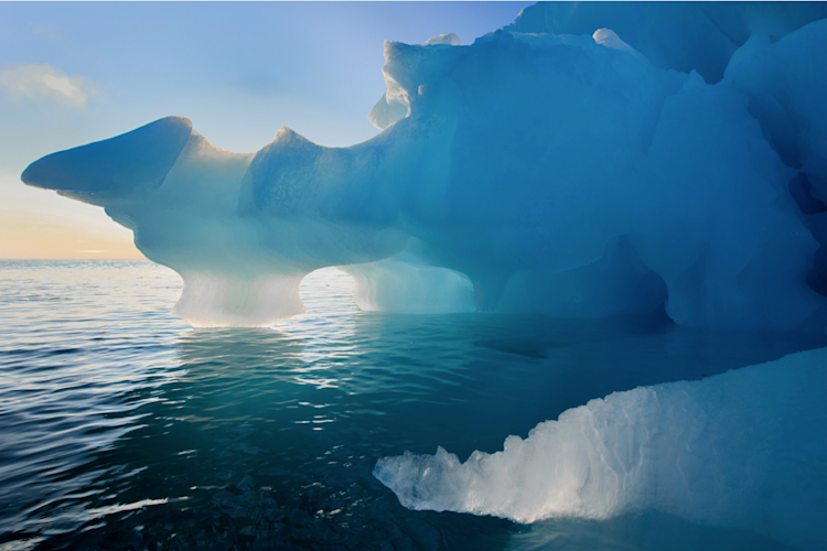 Arctic sunset behind icebergs