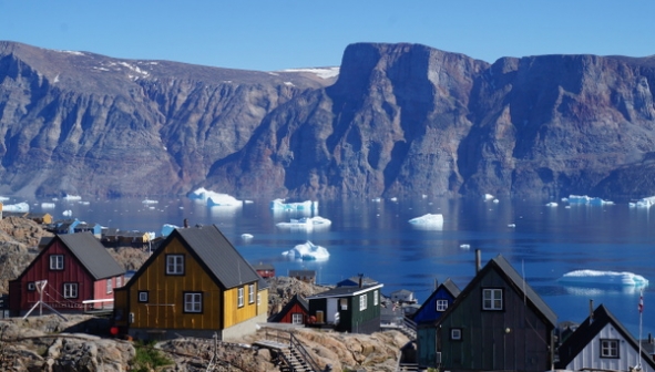 Photo of Uummannaq, Greenland. Icerberg chunks float in the water