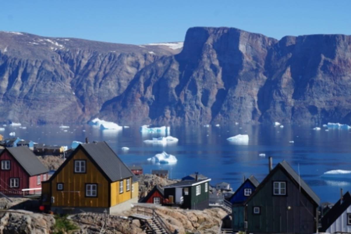 Photo of Uummannaq, Greenland. Icerberg chunks float in the water