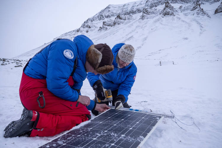 BJ Kirschhoffer and Krista Wright set up a flexible solar panel in Svalbard