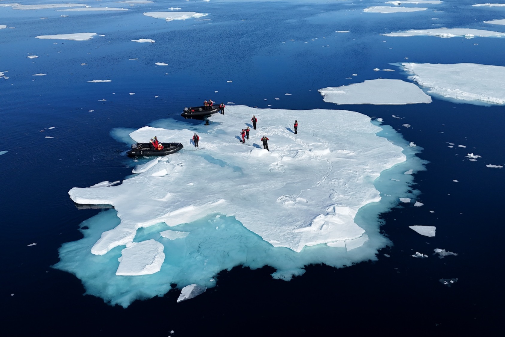 A guide leads a tour group on an ice floe in Svalbard, Norway