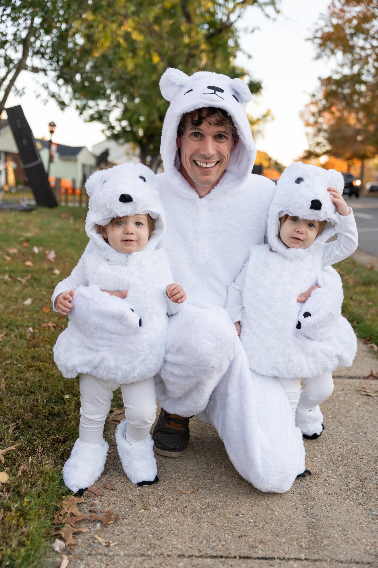 John Whiteman and his twin daughters in polar bear costumes on Halloween