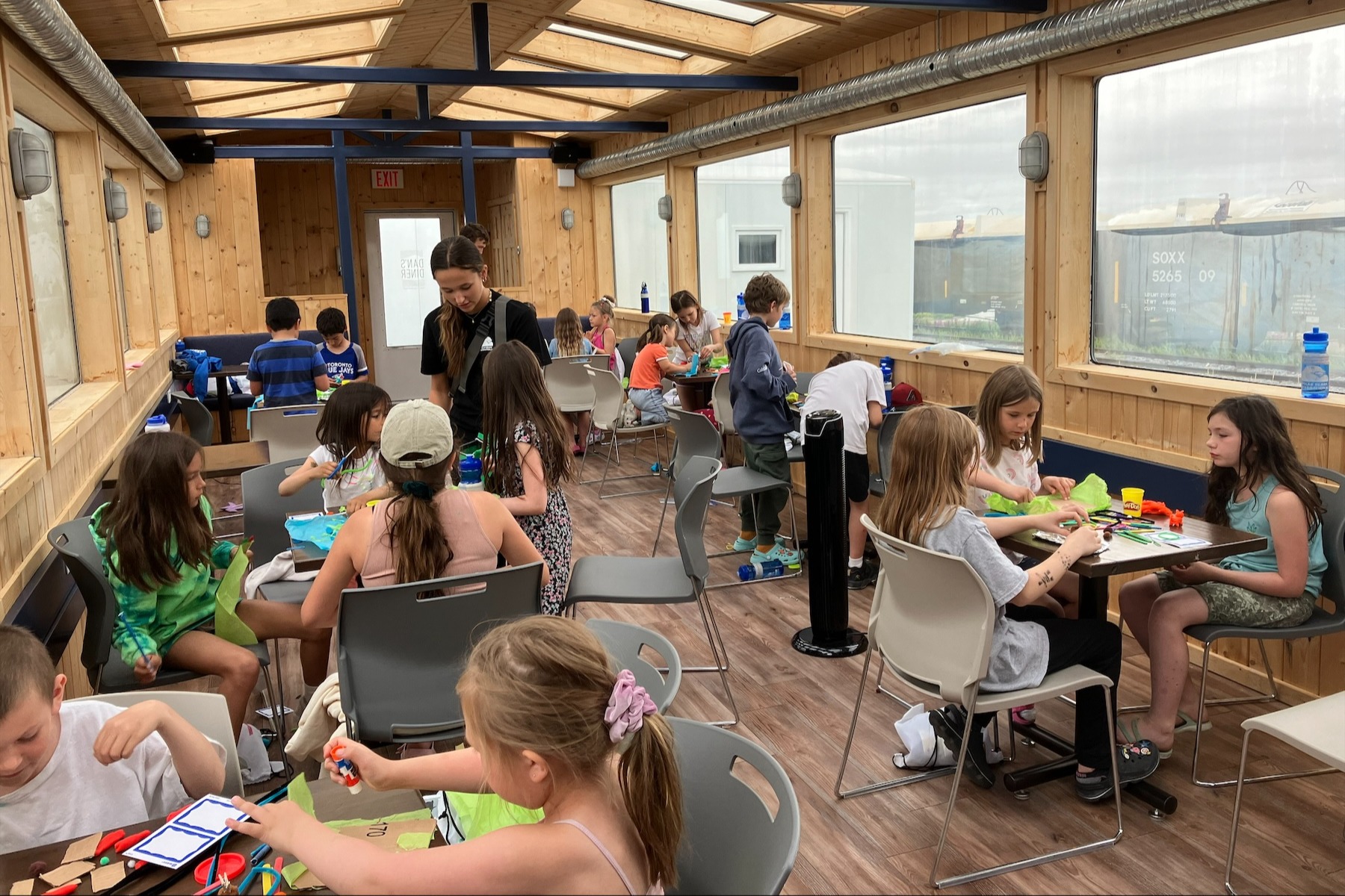 Children create crafts on the Tundra Buggy Lodge during summer camp in Churchill