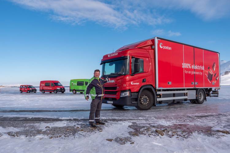 Olaf Ervik of Bring Cargo Svalbard AS, in front of his fleet of electric delivery vehicles
