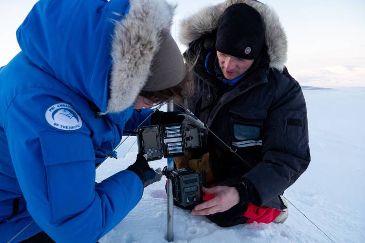 BJ Kirschhoffer and Joanna Suhlich set up a remote camera for Polar Bears International's maternal den study