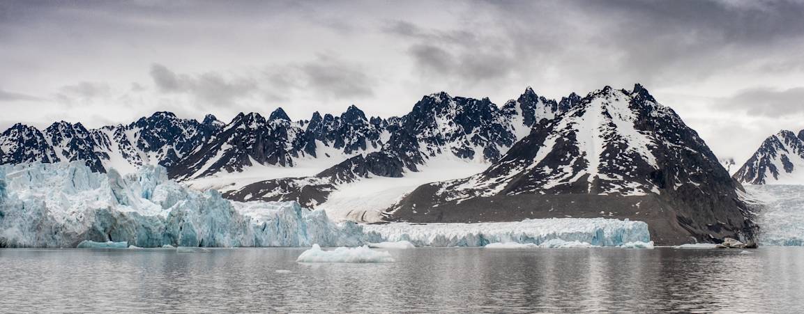 Mountains at the edge of a glacier as seen from the water in Svalbard