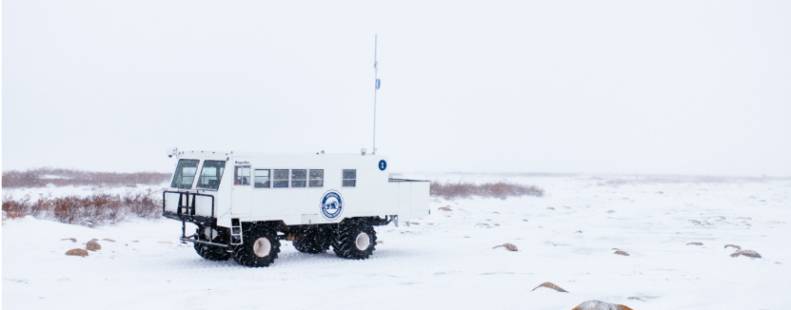 Tundra Buggy One making its way across the snowy tundra 