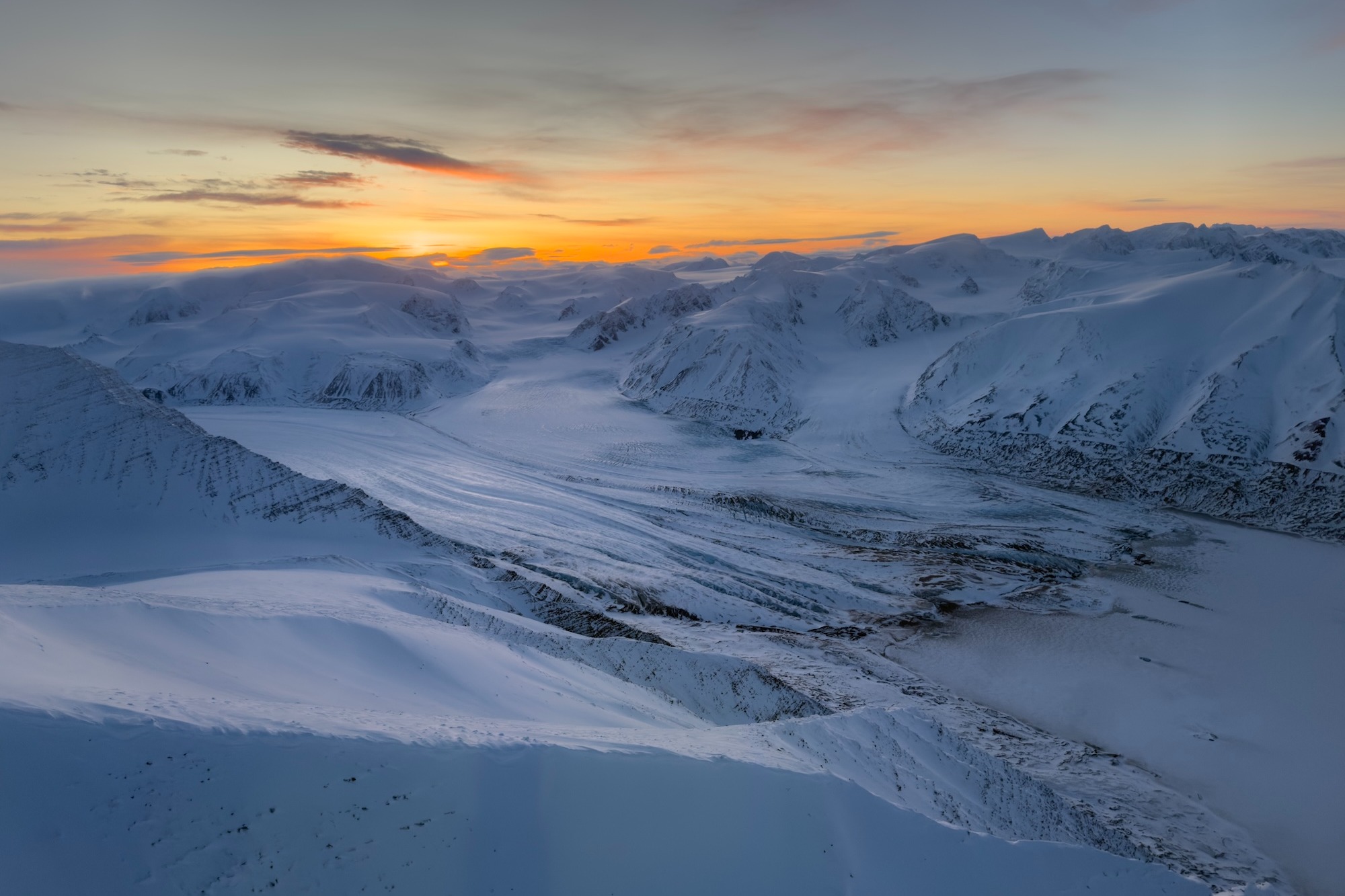 The sunset over snowy mountains in Svalbard