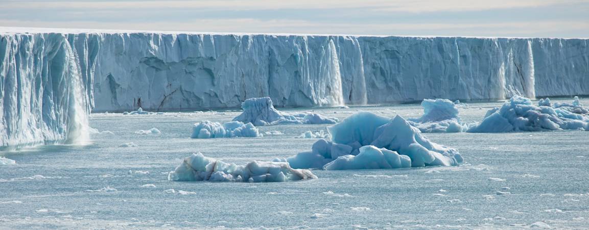 A large glacier with waterfalls pouring off the sides