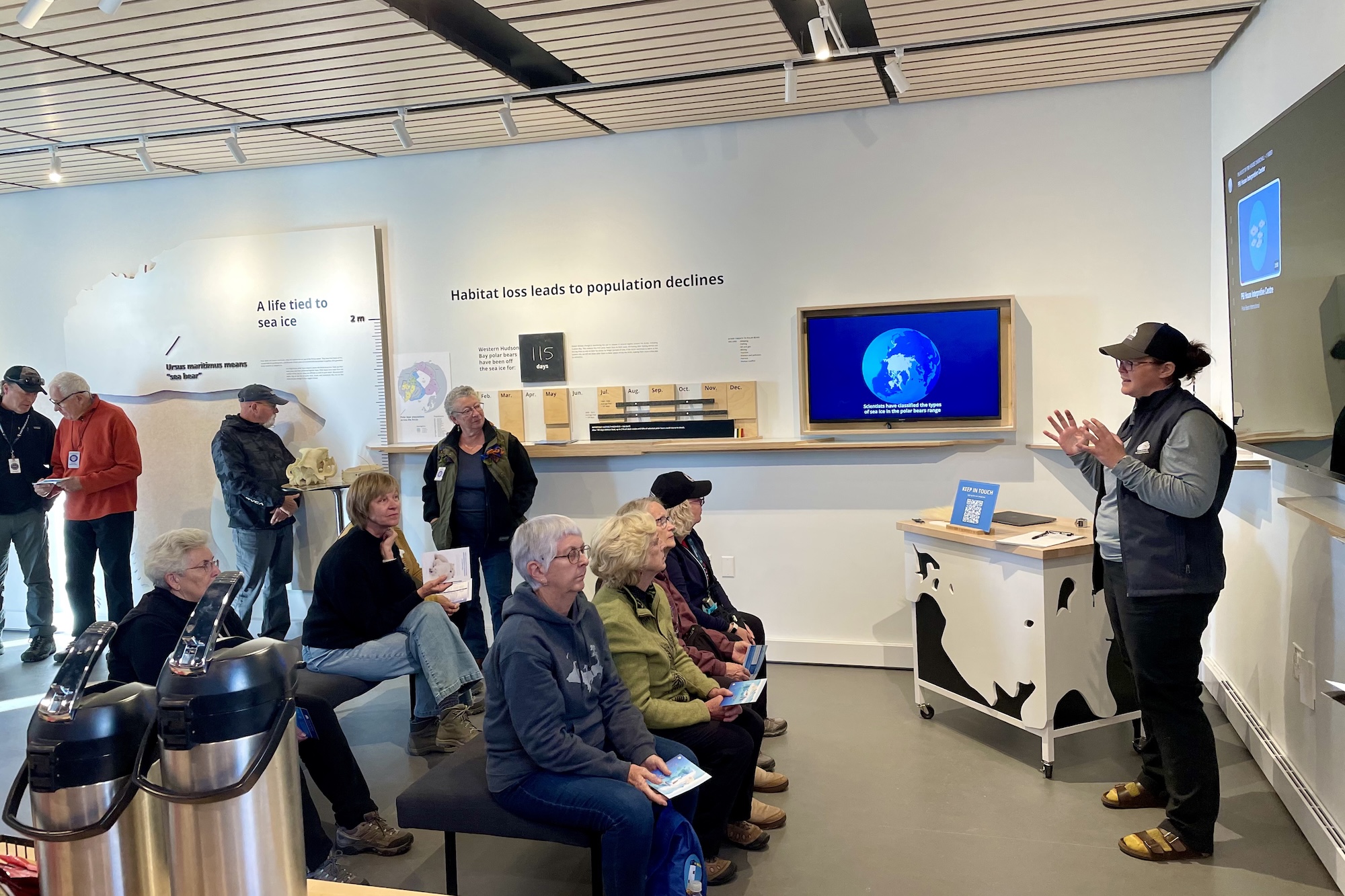 Kayla McCurry gives a presentation to guests in the PBI House