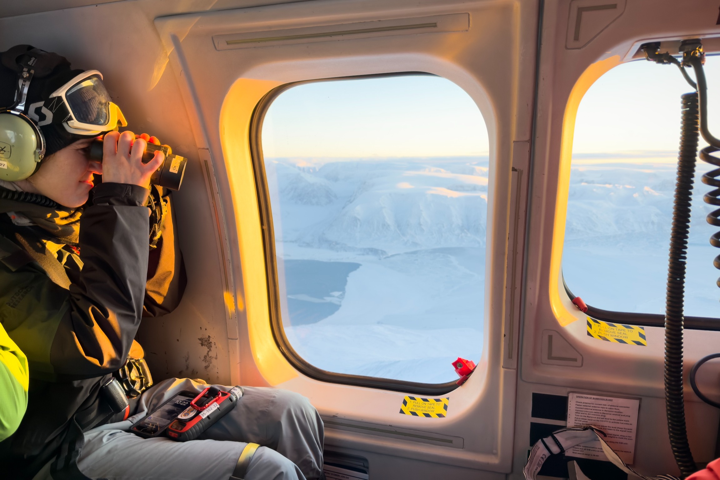 Dr. Louise Archer in a helicopter in Svalbard