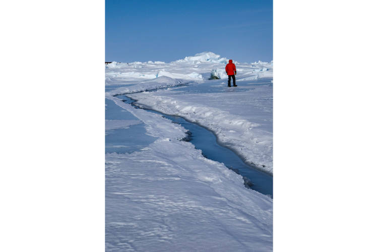  John McClelland stands beside a lead in the sea ice