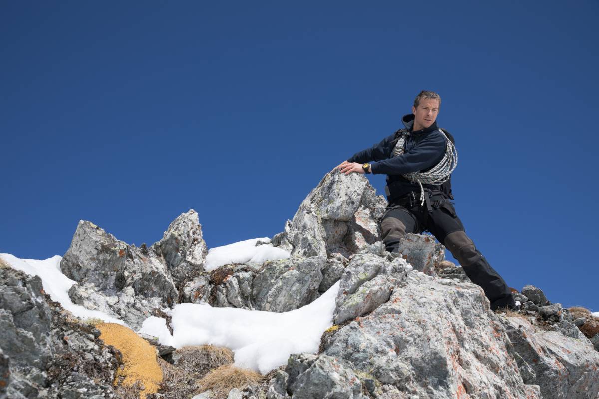 Television host Bear Grylls on a rocky outcropping in the Arctic.