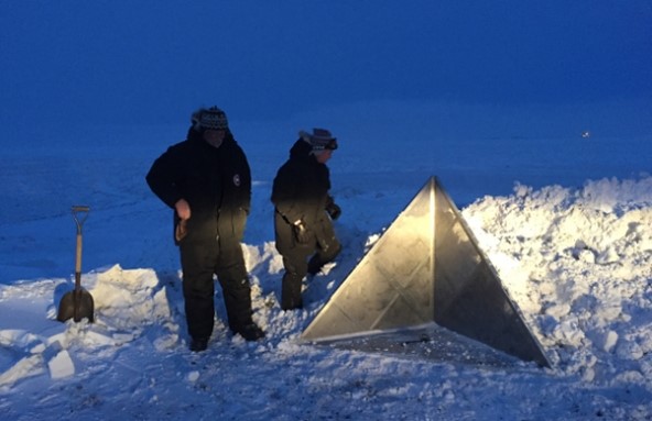 Team members secure a corner reflector on Alaska's North Slope to calibrate the radar, ensuring the accuracy of the signal and the location of objects found