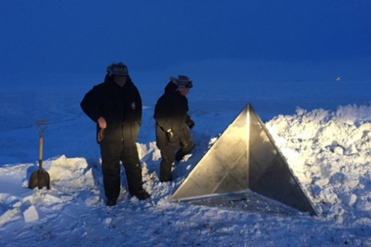 Team members secure a corner reflector on Alaska's North Slope to calibrate the radar, ensuring the accuracy of the signal and the location of objects found