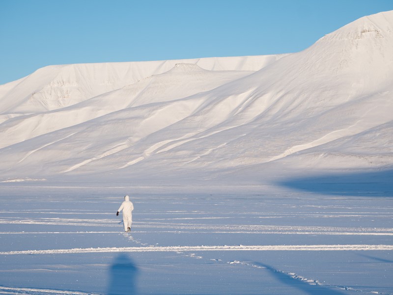 Scientist Nicholas Pilfold wearing white to test maternal den cams