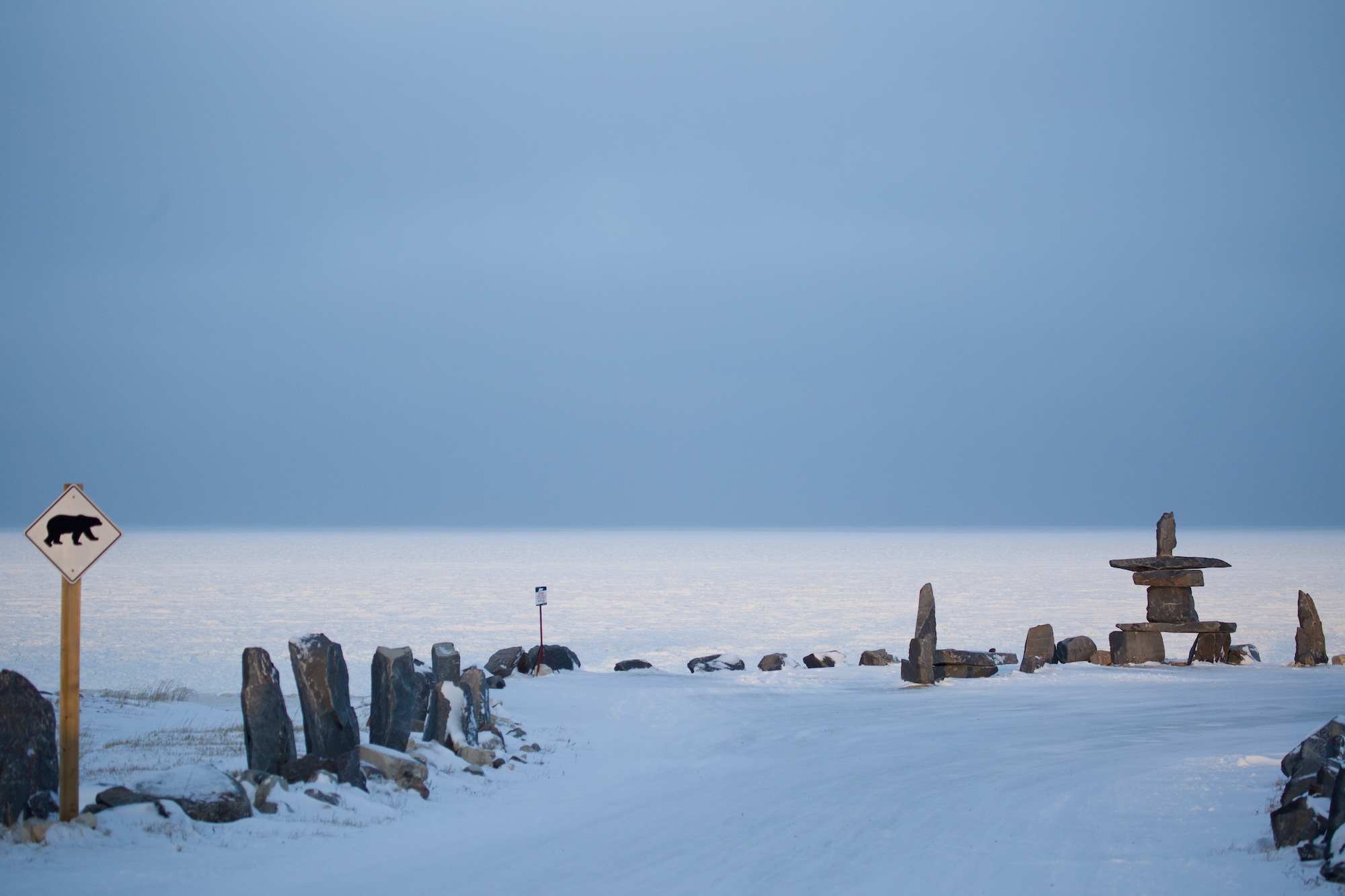 Churchill Inukshuk with Polar Bear Sign Near Beach