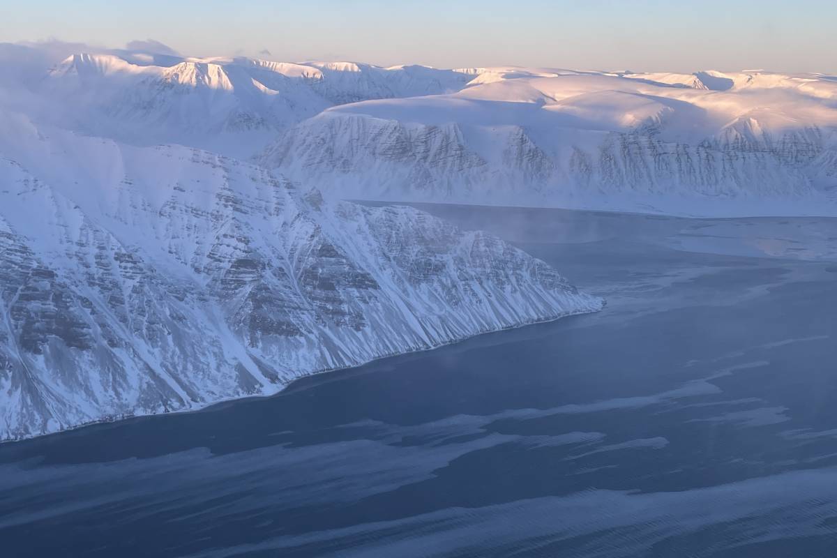Aerial image of Svalbard mountains and water in winter